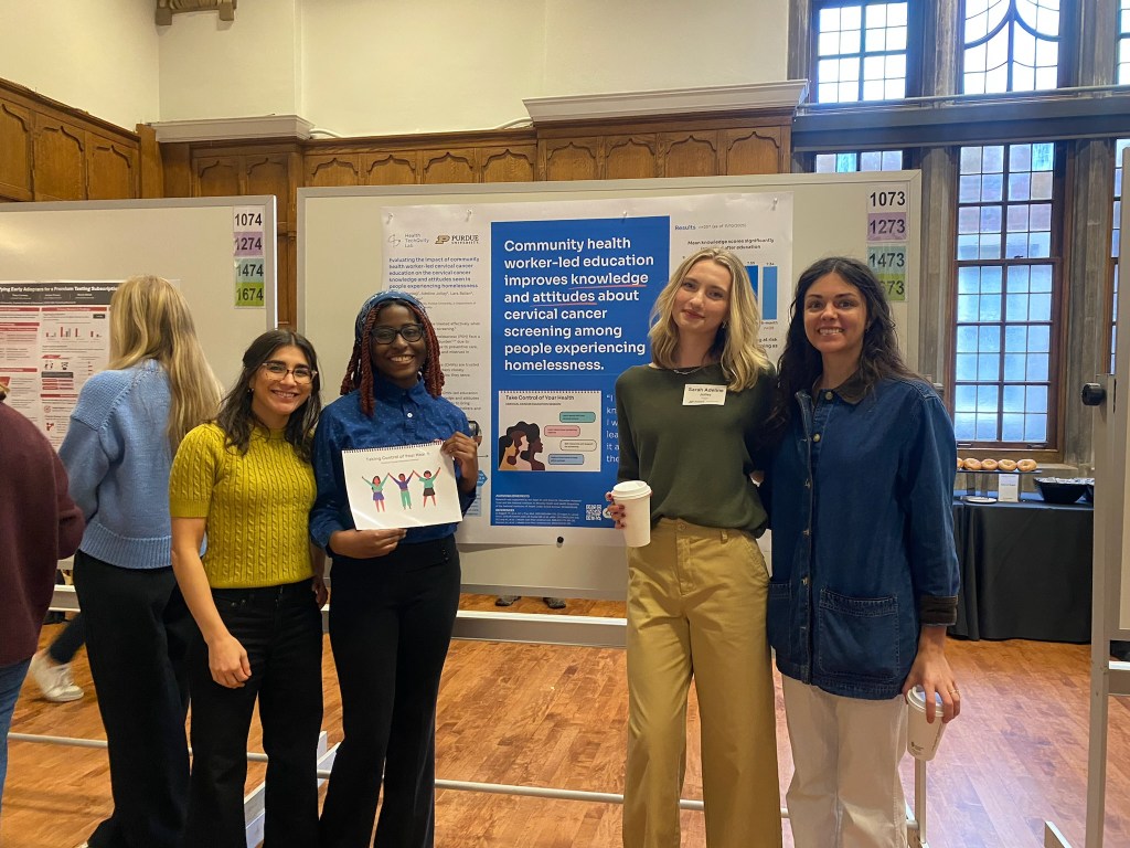 Jessica and Adeline presenting their poster at the Fall Undergraduate Research Conference, posing next to lab member Becca and Lara